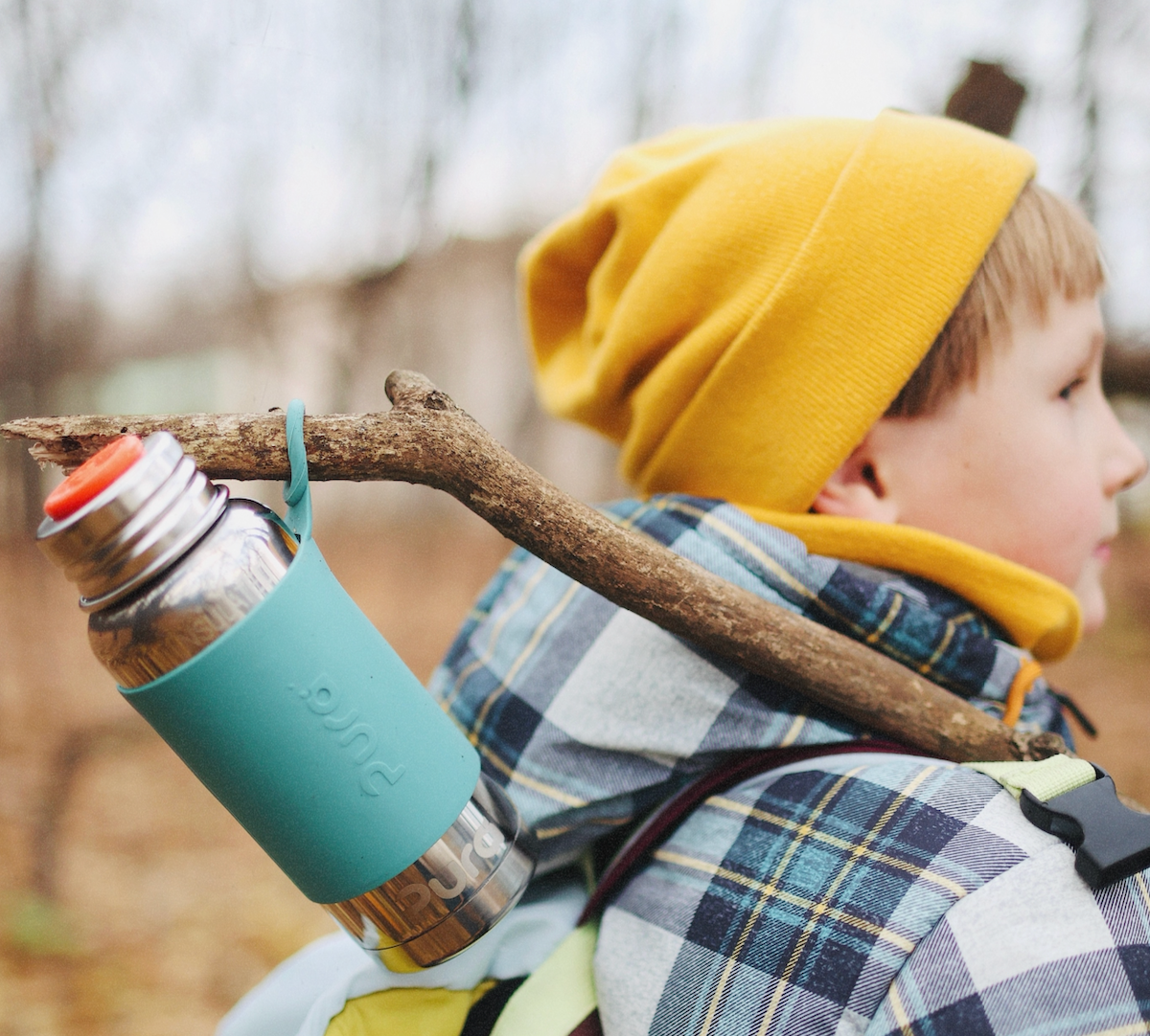 Caucasian boy hiking in winter with a Pura stainless steel water bottle