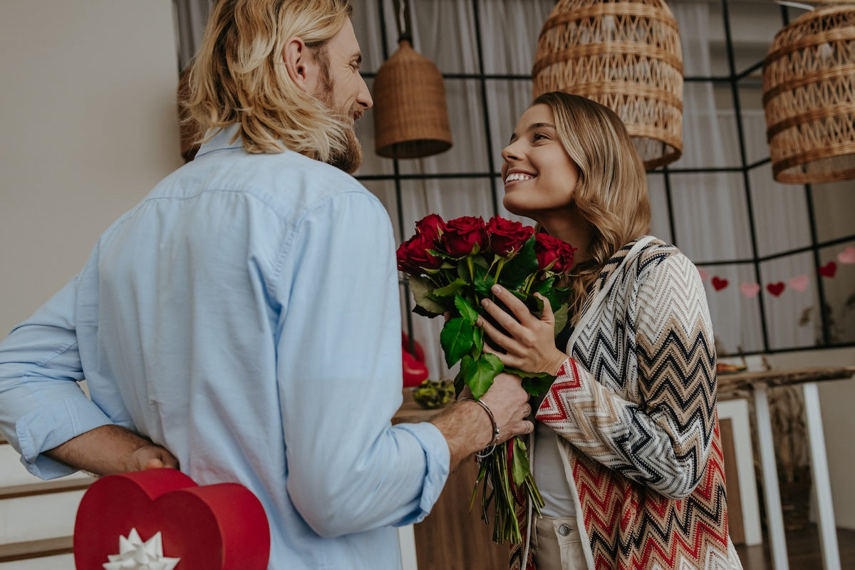 Caucasian couple exchanging Valentine’s Day gifts